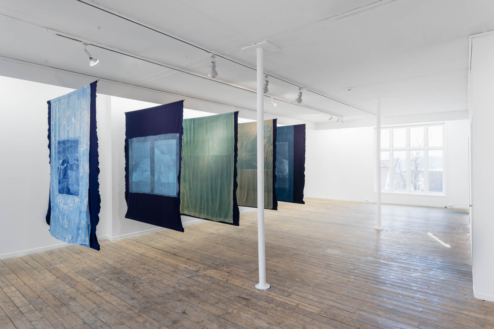 "Blowing soap bubbles into the crystal-clear sky to see them freeze and pop", five hand-dyed and screen printed textiles on steel tubes, indigo, cyanotypes, phycocyanin, acrylic paint